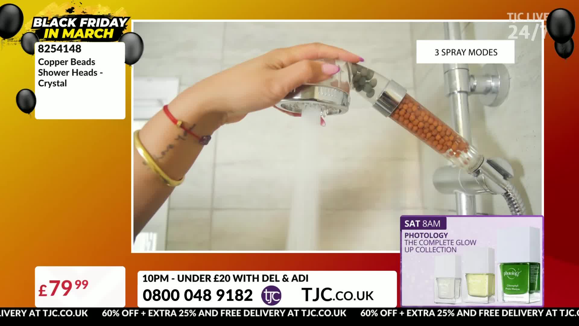 Water streams from the showerhead, its clear casing filled with copper beads. A hand holds the showerhead, demonstrating its function.