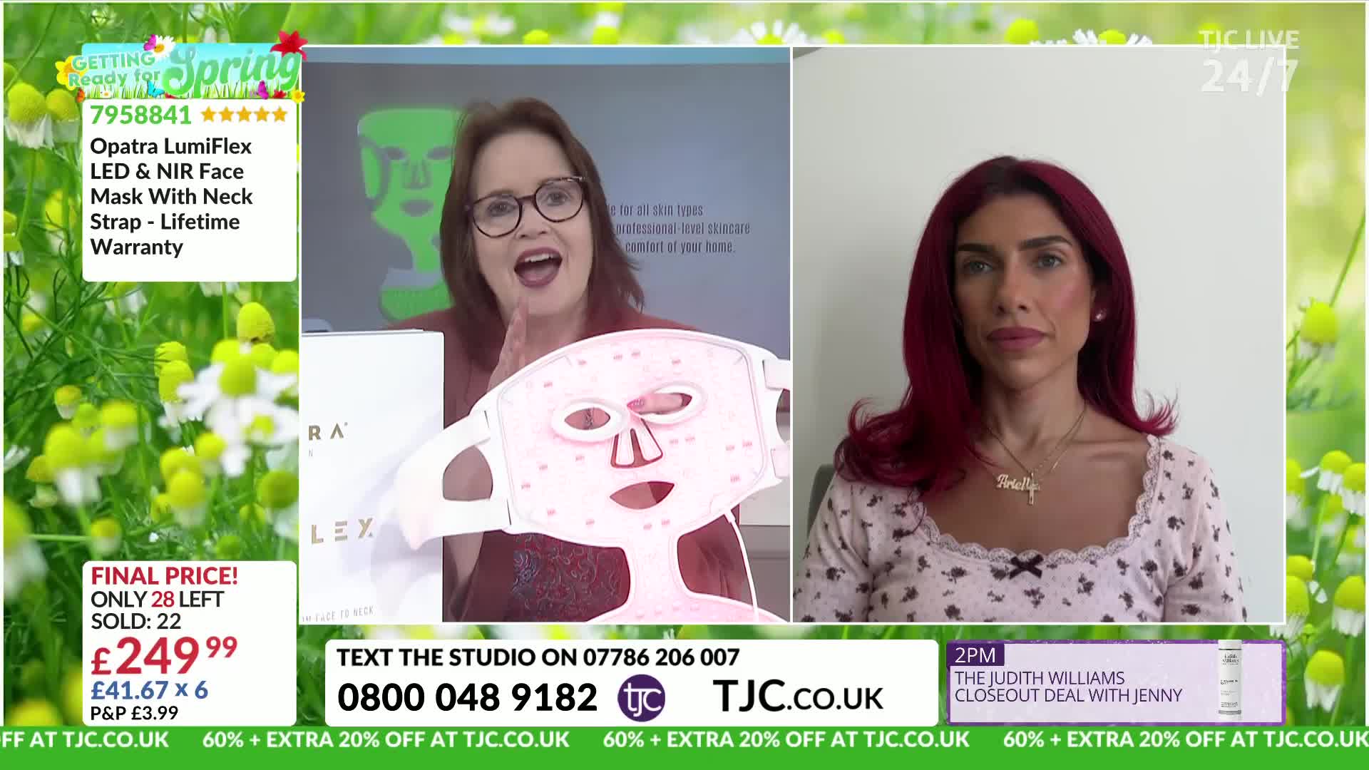 The presenter holds up a pink LED face mask, its lights glowing. On the right, a woman with dark red hair looks directly at the camera.