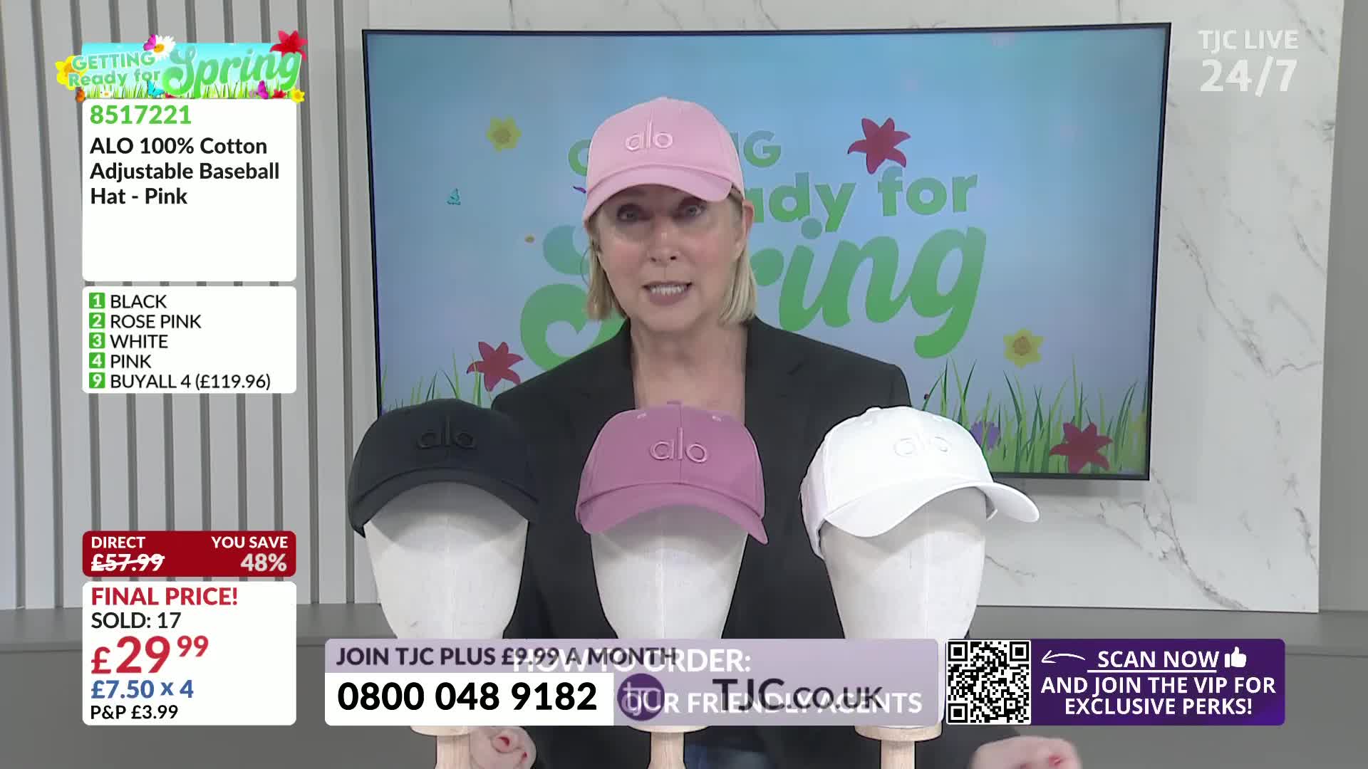 A woman stands behind three baseball caps displayed on mannequins: one black, one rose pink, and one white. The TJC logo is visible on screen, along with details about the hats and a phone number for ordering.