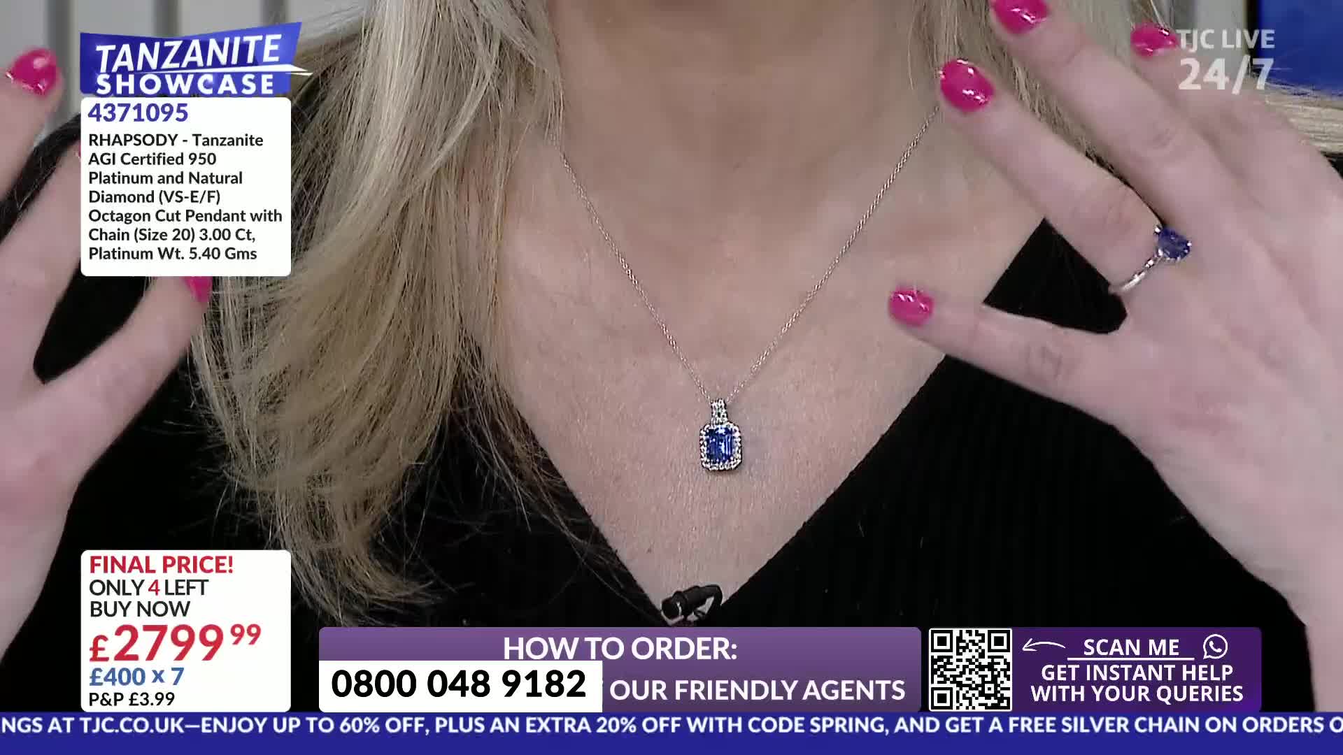 A woman's hands, adorned with bright pink nail polish, gesture towards a sparkling blue pendant necklace and a matching ring. The TJC logo and product details are visible on screen.
