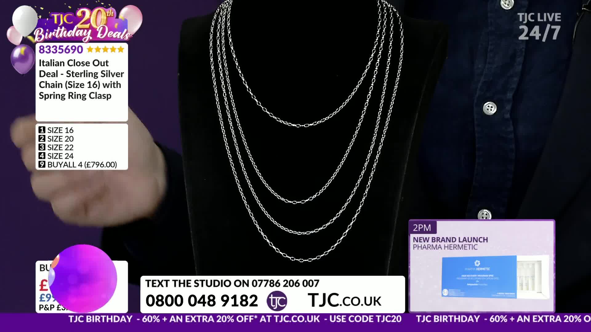 A hand gestures towards a display of layered silver necklaces. The TJC logo and birthday promotions are visible on screen.