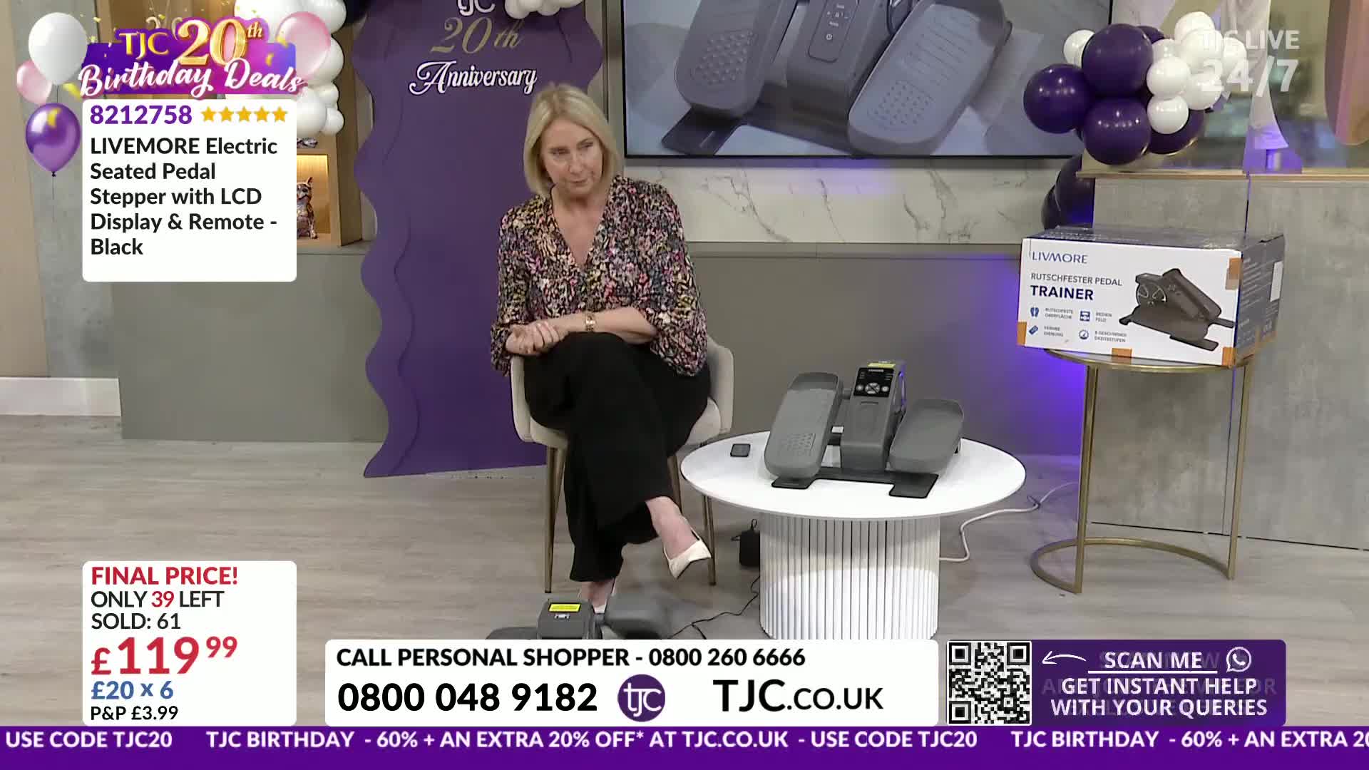 A woman is demonstrating a seated pedal exerciser on a white table. The TJC logo is visible, celebrating their 20th anniversary.