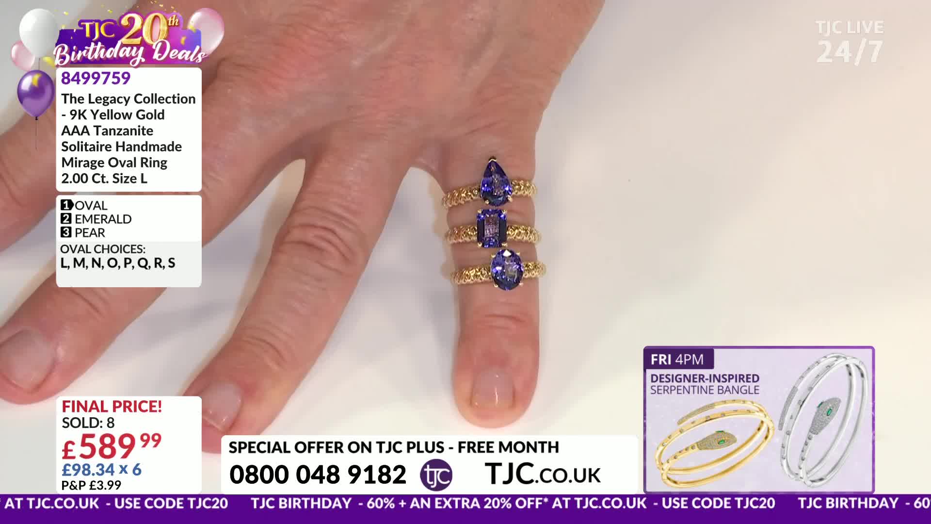 Three gold rings, each set with a large, deep blue tanzanite, are stacked on a finger. The stones are cut in different shapes: oval, emerald, and pear.