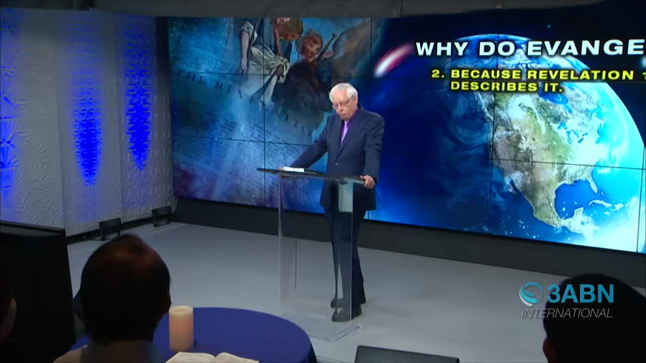 A man in a suit stands at a clear podium, reading from a script. Behind him, a large screen displays text and an image of Earth, with the 3ABN International logo in the corner.
