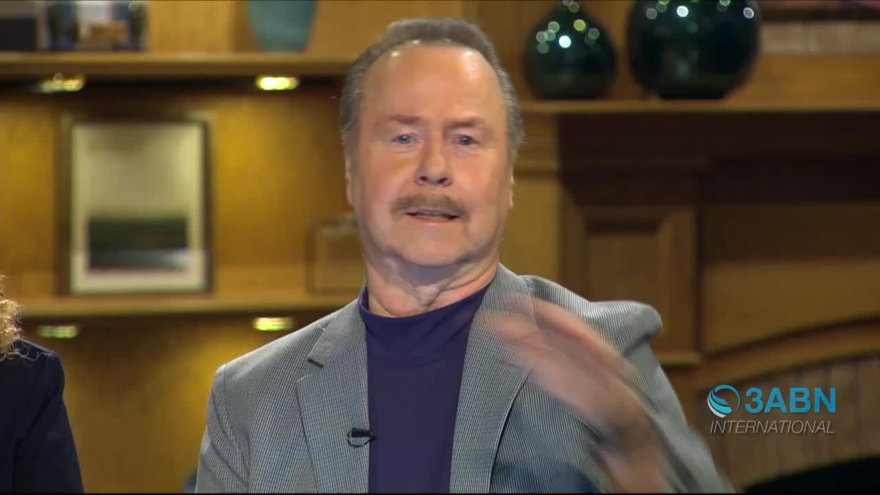 A man in a gray blazer gestures with his right hand, the movement blurring slightly. The 3ABN International logo is visible in the bottom right corner.
