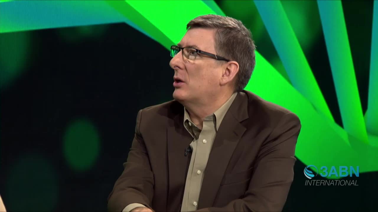 A man in a brown blazer and glasses speaks, his mouth open as if mid-sentence. The 3ABN International logo is visible on the right side of the screen.
