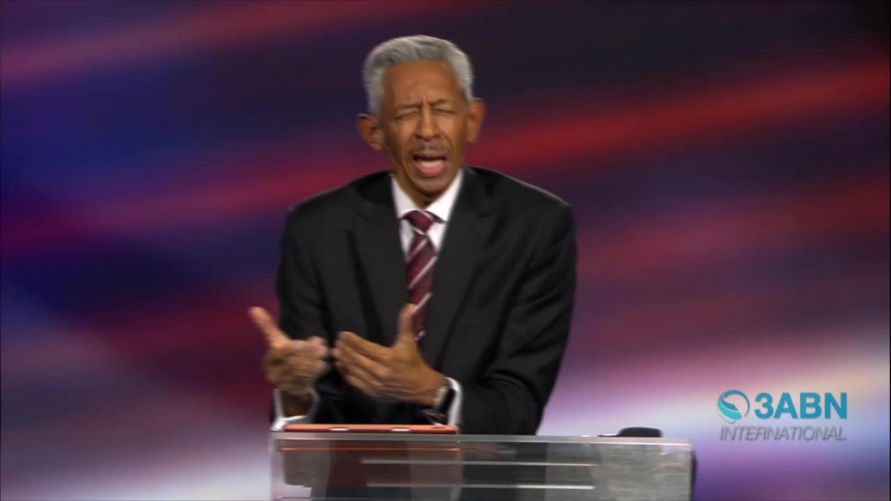 A man in a suit gestures with both hands as he speaks, his mouth open. The 3ABN International logo is visible on the right.
