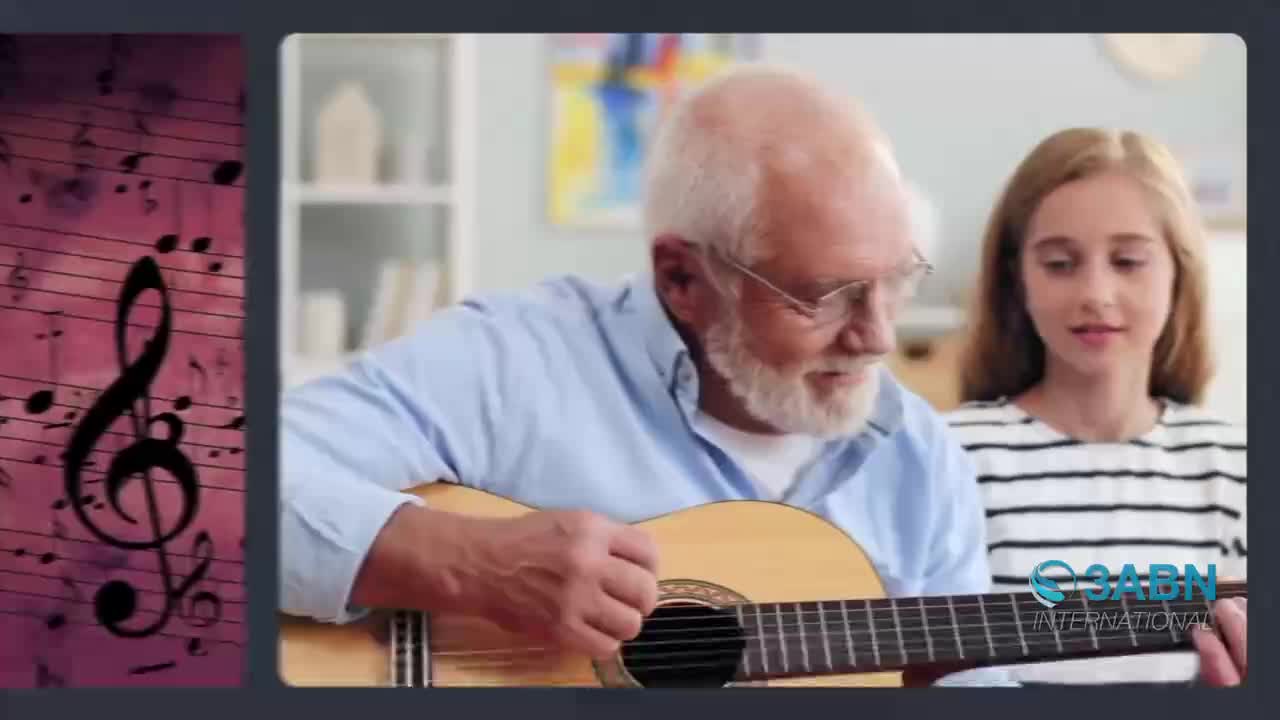 An older man with a white beard plays an acoustic guitar while a young girl watches him. Beside them, musical notes drift across a pink background, a familiar sight from 3ABN International programming.