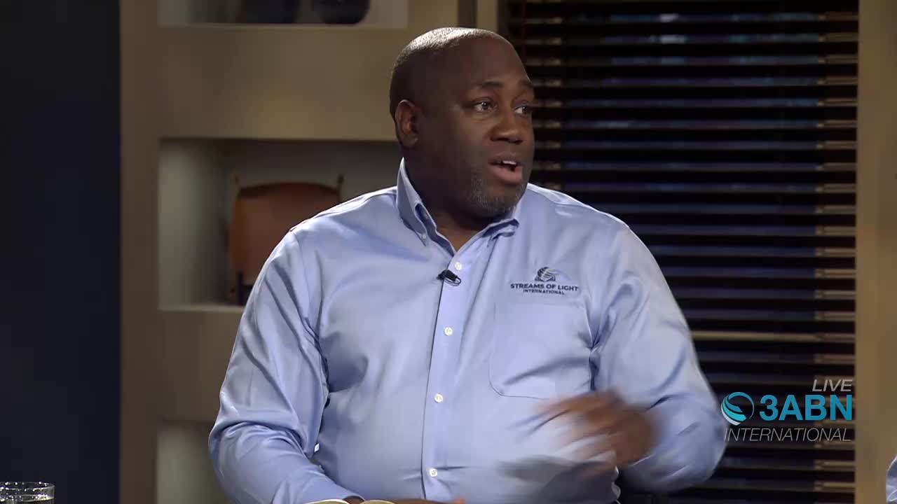 A man in a light blue shirt with a "Streams of Light International" logo speaks animatedly, gesturing with his right hand. A "LIVE 3ABN INTERNATIONAL" graphic appears in the lower right corner.
