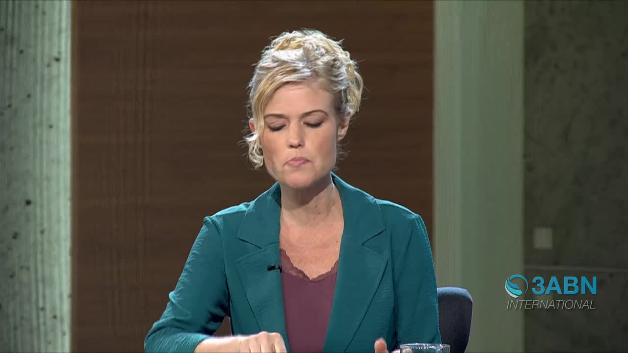 A woman with blonde hair pulled back is speaking, her gaze directed downwards. She wears a teal blazer over a maroon top, and the 3ABN International logo is visible in the lower right corner.