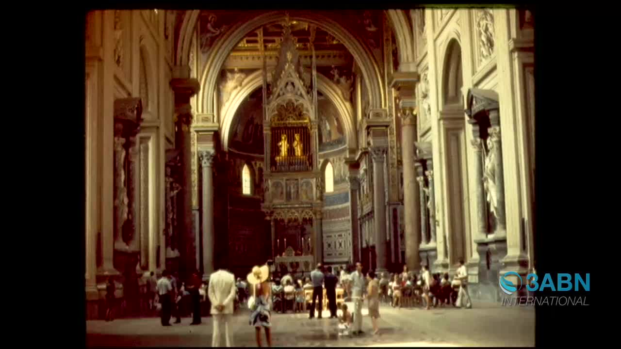 People are milling about inside a grand cathedral, sunlight streaming through arched windows. A group of visitors gathers near the altar, their attention drawn to the ornate decorations.