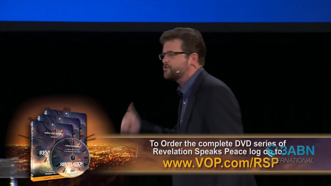 A man in a suit gestures as he speaks, while a graphic displays DVD covers and ordering information for 3ABN International. The background is a dark stage with a blue border at the top.