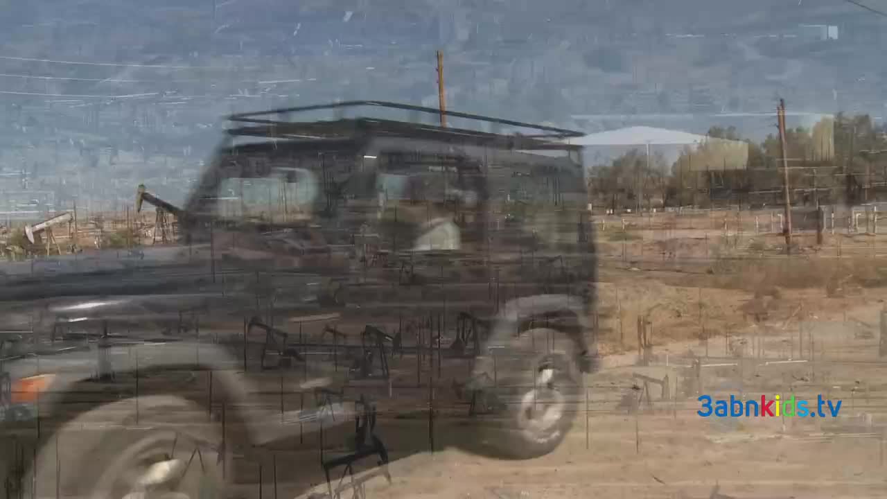 A black SUV is driving through a dusty area with oil pumps in the background. The 3abnkids.tv logo is visible in the bottom right corner.
