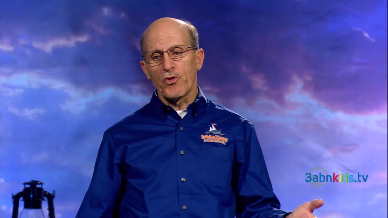 A man in a blue shirt gestures with his hands, speaking in front of a cloudy backdrop. The 3ABN Kids logo is visible on the screen.
