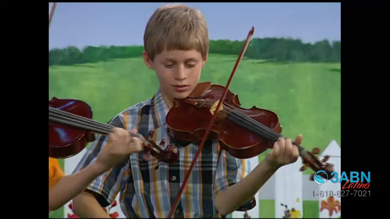 A young boy, dressed in a plaid shirt, holds a violin and focuses intently on the strings. His bow moves across the instrument as he plays, against a backdrop of a painted landscape.
