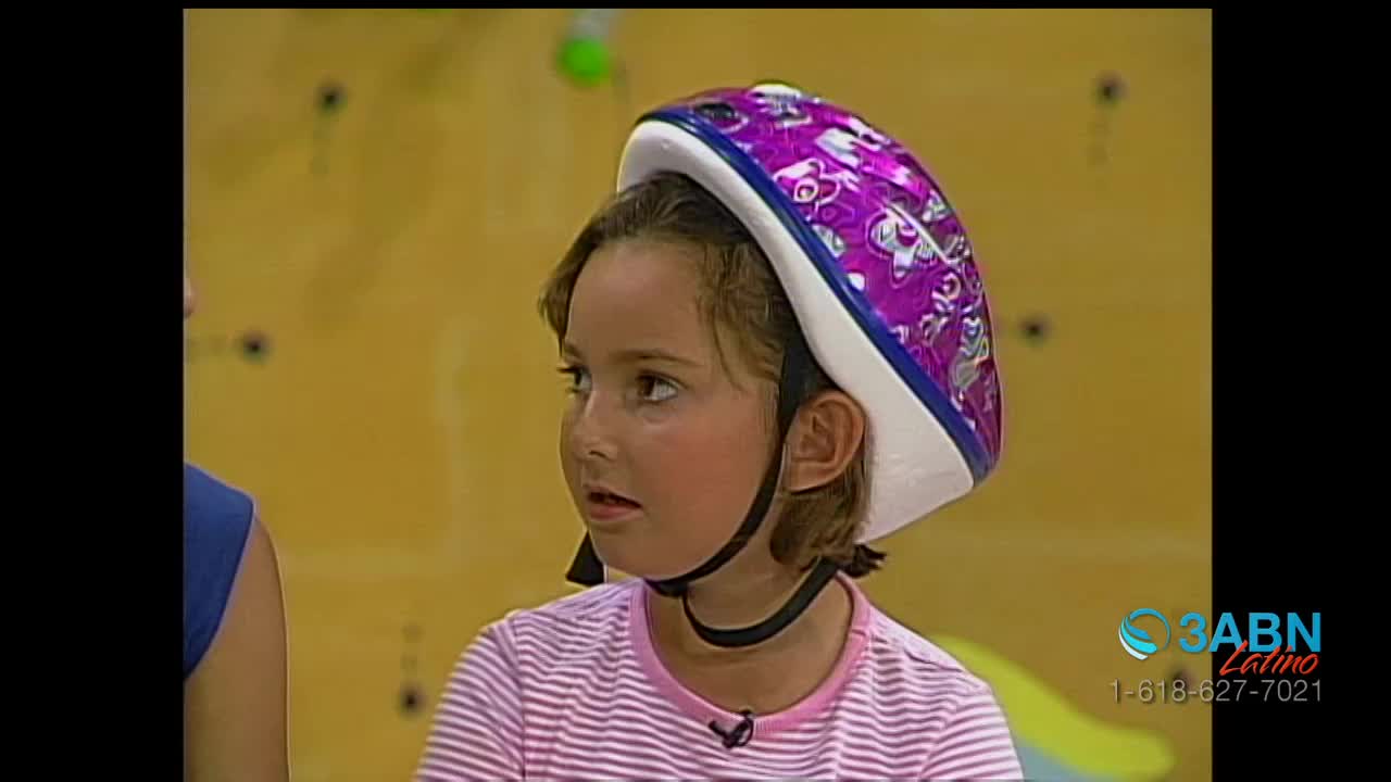 A young girl, wearing a patterned helmet, looks slightly to her left. The 3ABN Latino logo is visible in the corner of the screen.
