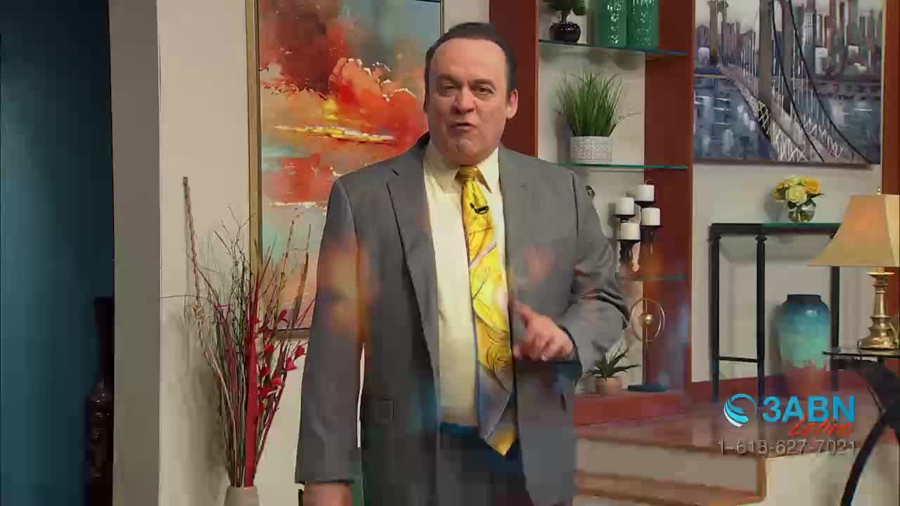 A man in a gray suit and a yellow tie is gesturing with his right hand, speaking directly to the camera. The 3ABN Latino logo is visible in the bottom right corner, indicating a broadcast from the United States.
