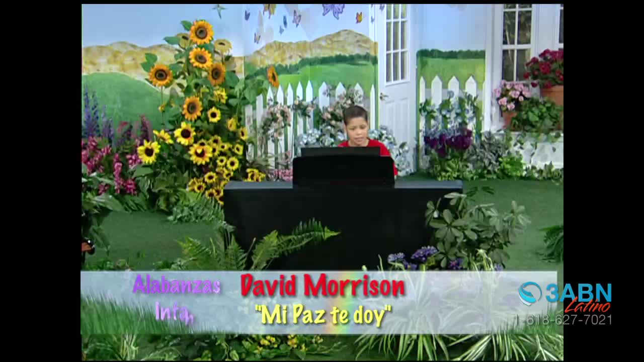 A young boy sits at a black piano, playing in a brightly colored garden setting. The 3ABN Latino logo is visible on the bottom right.
