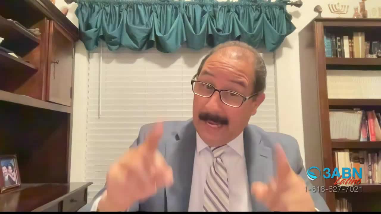 A man in a suit gestures with both hands, his fingers spread. He speaks with conviction, his mustache prominent. A 3ABN Latino logo appears in the lower right corner.