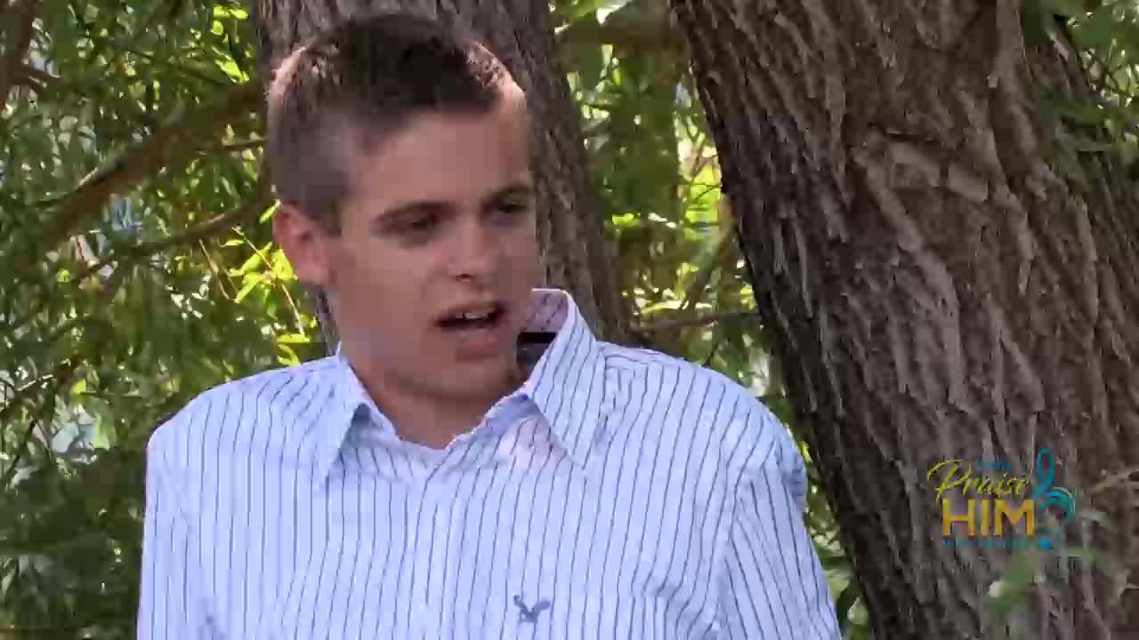 A young man in a striped shirt speaks outdoors, his mouth open as if mid-sentence. The "Praise Him" logo from the 3ABN Praise Him Music Network is visible in the corner.
