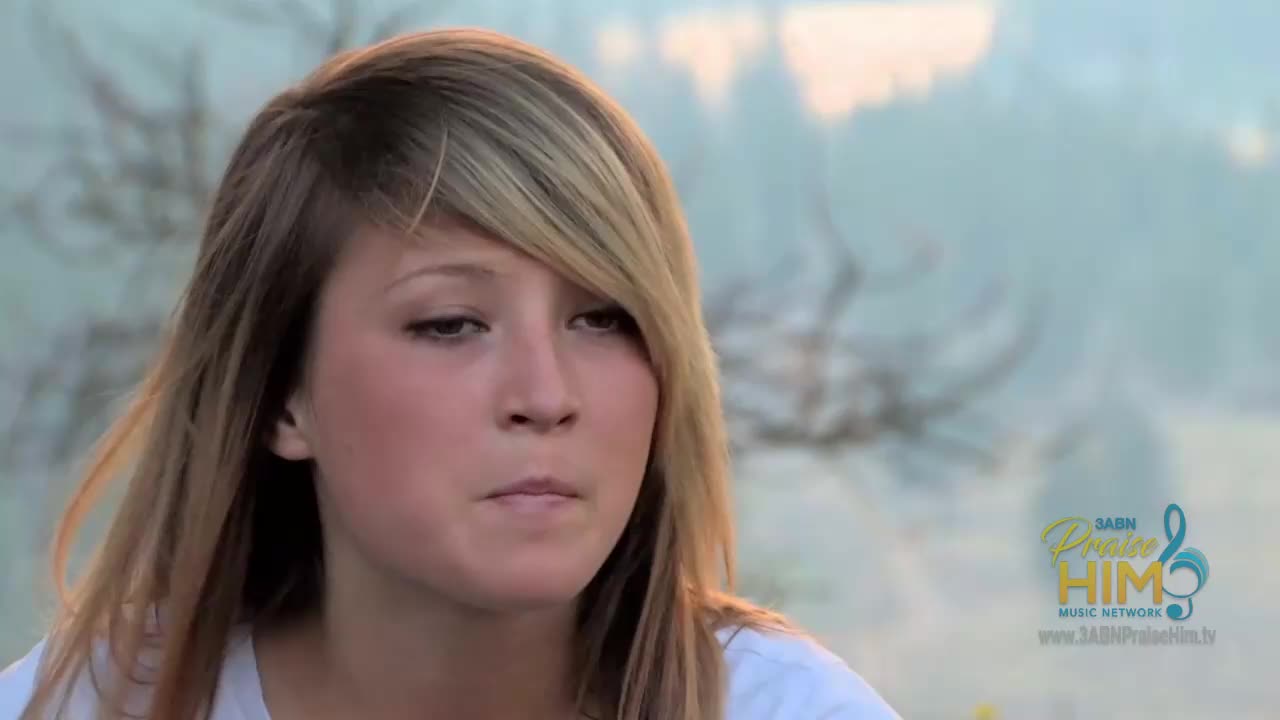 The young woman is looking down, her expression thoughtful. The 3ABN Praise Him Music Network logo is visible in the corner of the screen.

