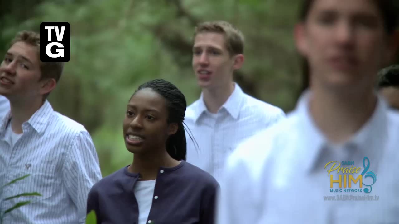 A group of young people, some in white shirts, are singing outdoors. The scene is from the 3ABN Praise Him Music Network, a program broadcast in the United States.
