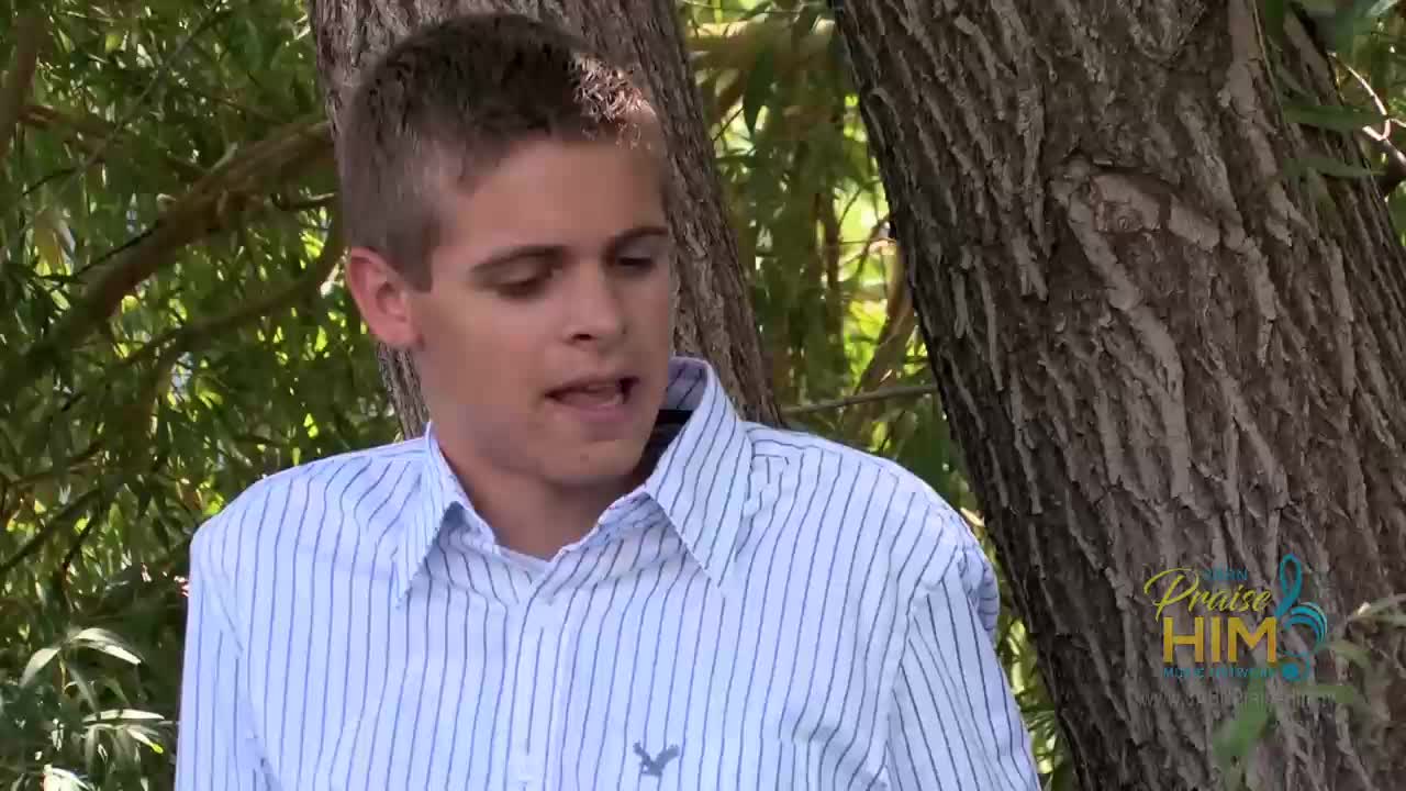A young man in a striped shirt speaks, leaning against a tree. The "Praise Him" logo of 3ABN Praise Him Music Network is visible in the corner.

