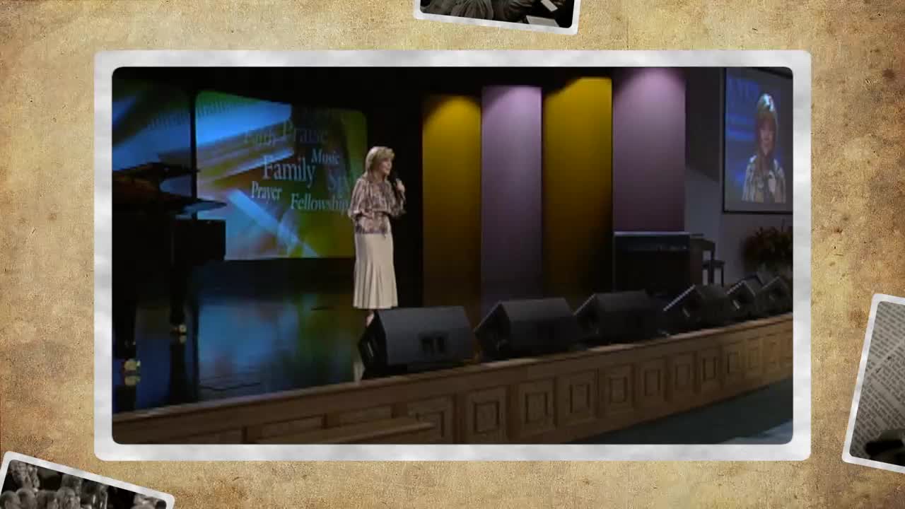 A woman in a long skirt stands on a stage, speaking into a microphone. Behind her, a screen displays words like "Family" and "Prayer," with the 3ABN Praise Him Music Network logo visible.