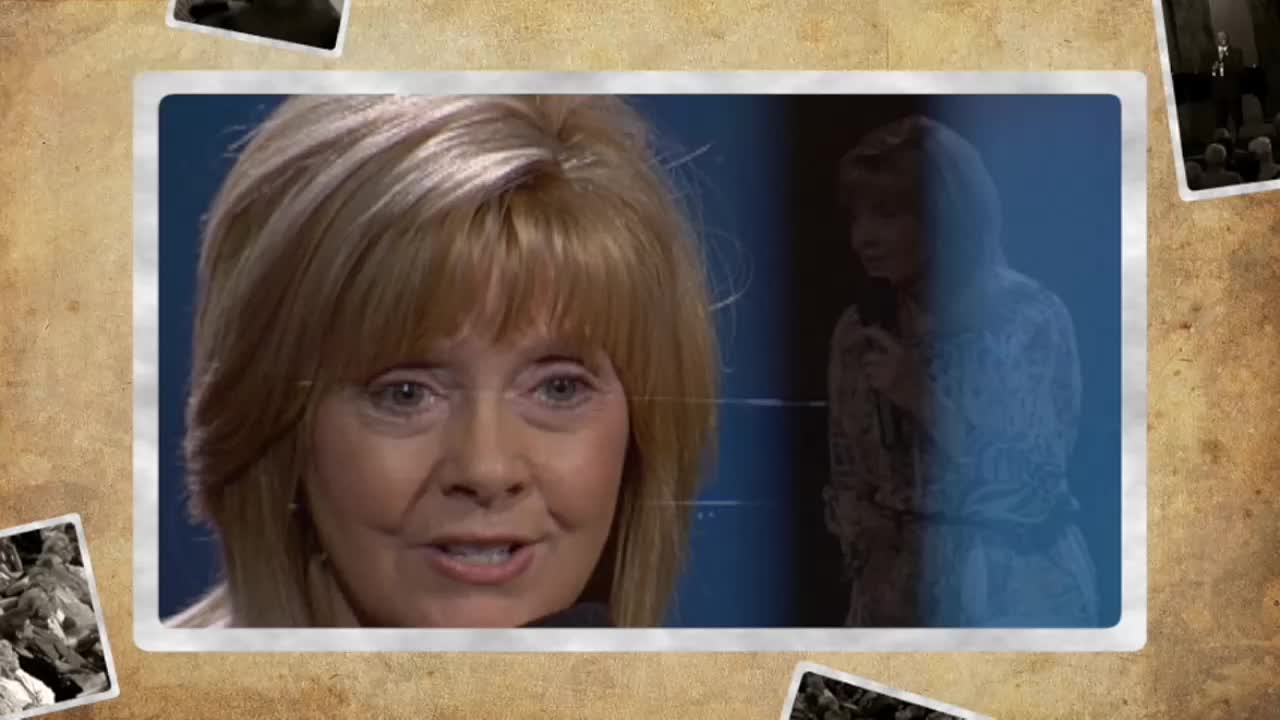 A woman with blonde hair speaks directly to me, her eyes bright. Behind her, a faded image shows a woman singing into a microphone on a stage.