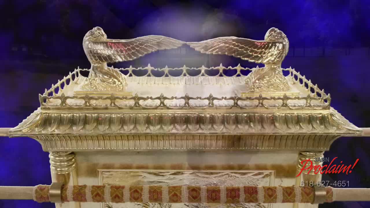 The golden Ark of the Covenant sits centered, the wings of the cherubim outstretched. A bright light shines between them, against a backdrop of deep blue.
