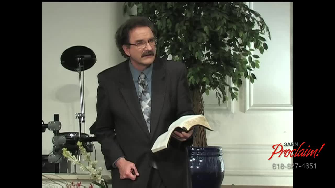 A man in a suit, holding an open book, gestures as he speaks. The 3ABN Proclaim! Network logo is visible in the bottom right corner.

