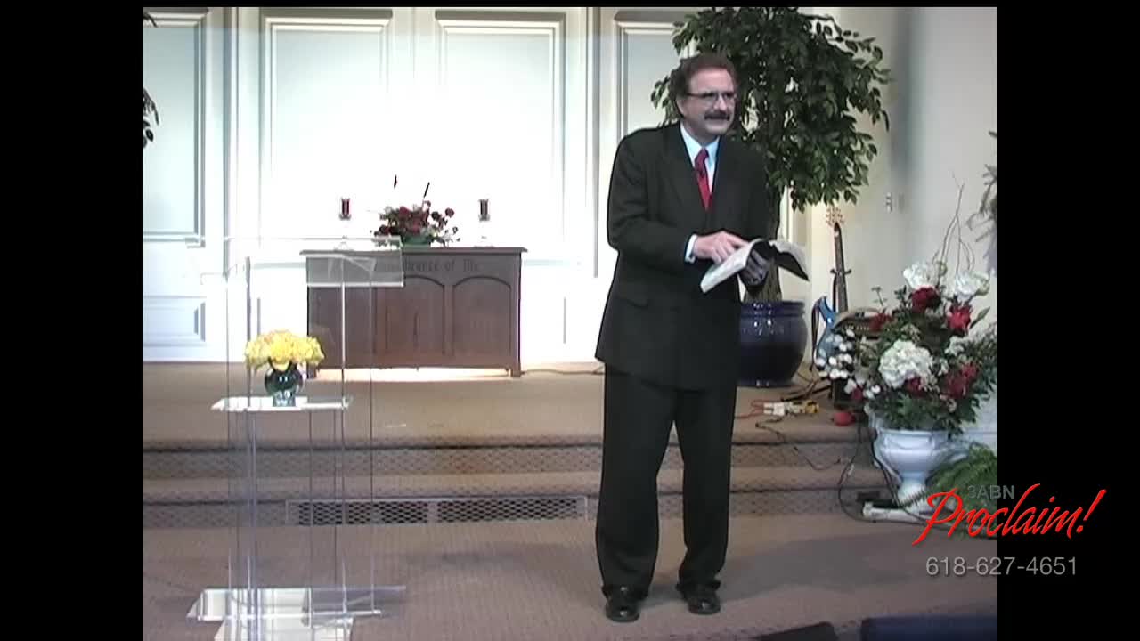A man in a suit stands at the front of a church, holding an open book. The 3ABN Proclaim! Network logo is visible in the corner.
