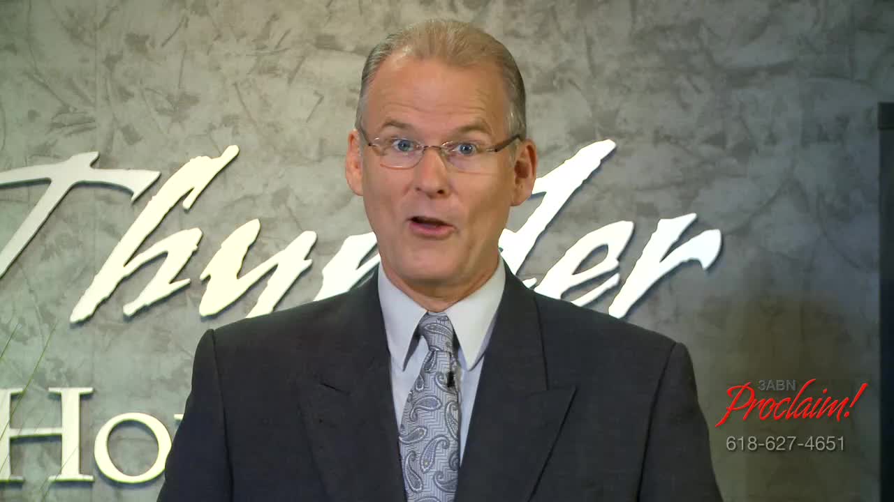 A man in a suit and tie is speaking, his mouth open as if mid-sentence. Behind him, a logo for "Thunder" and the 3ABN Proclaim! Network is visible.
