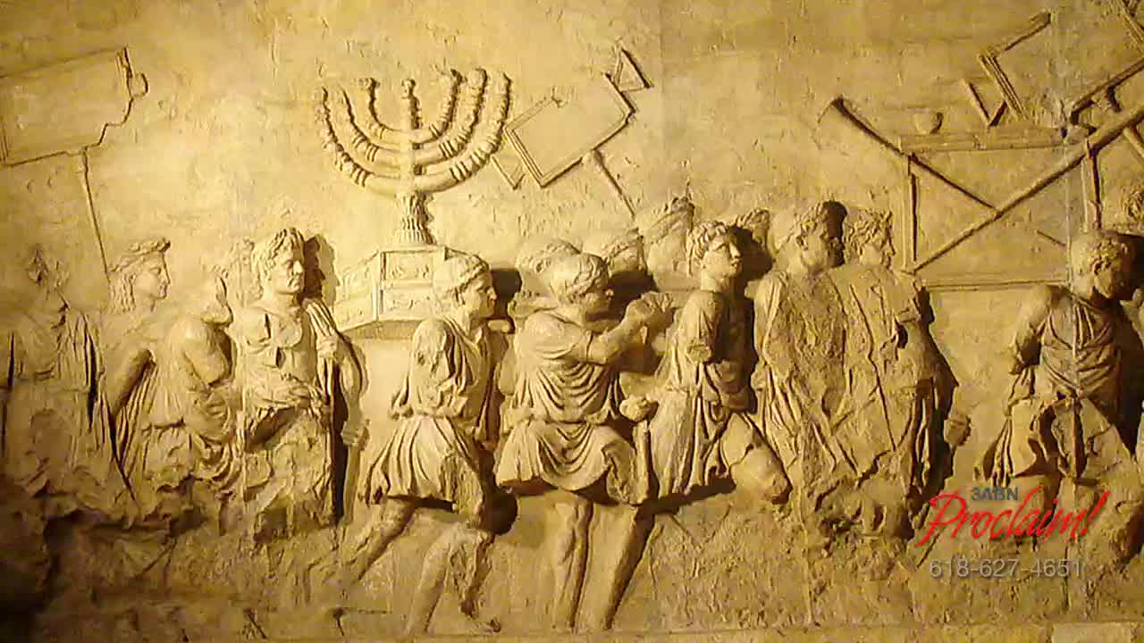A procession of figures, carved in relief, carries a large menorah and other objects. The scene, likely from ancient Rome, is presented by 3ABN Proclaim! Network.

