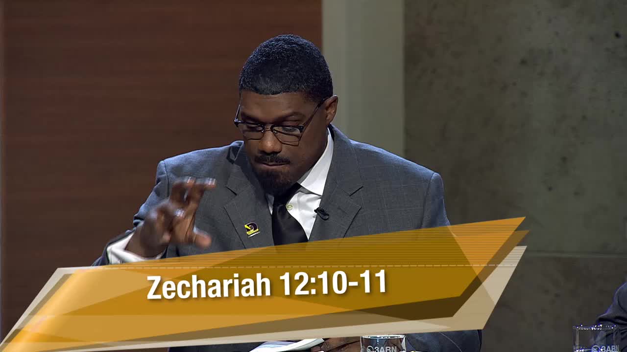 A man in a suit gestures with his right hand while looking down at a book. A graphic overlay displays "Zechariah 12:10-11" and the 3ABN Proclaim! Network logo.