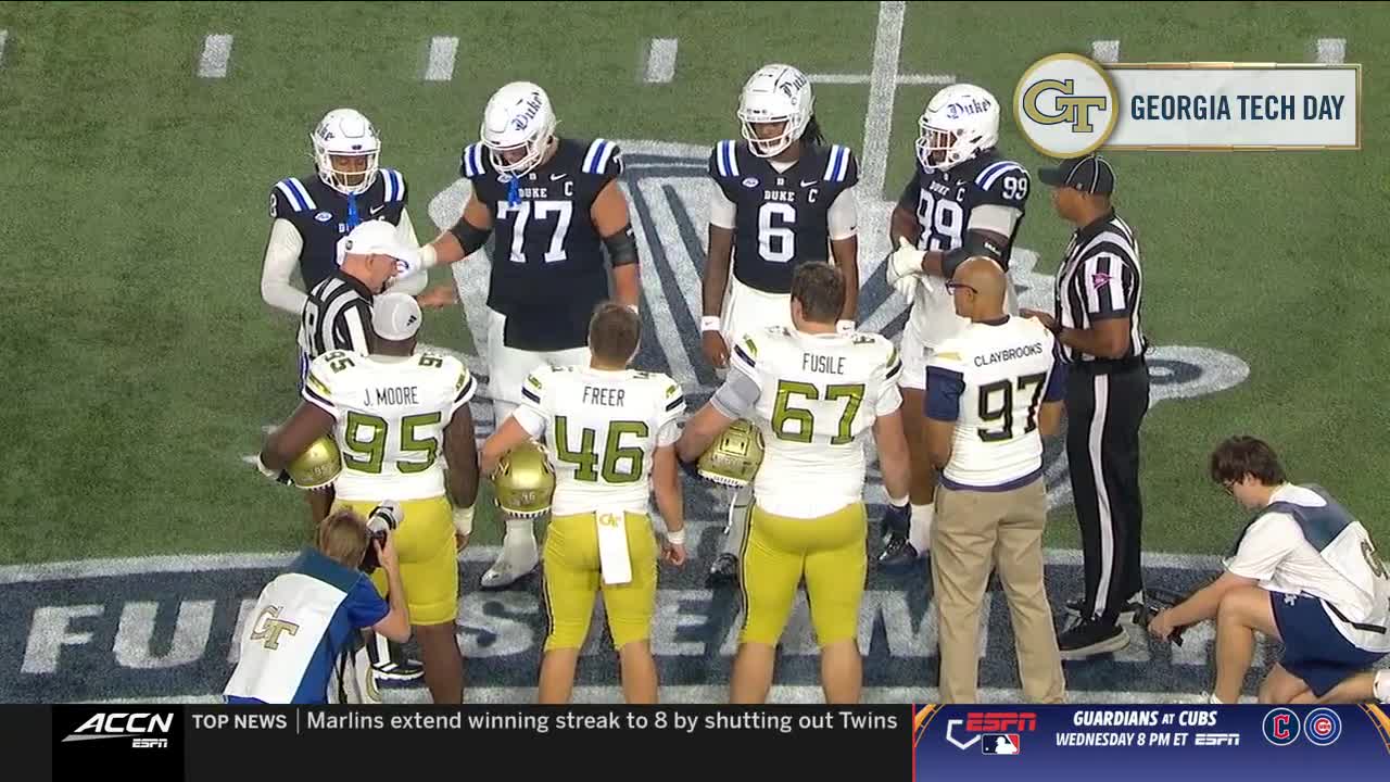 Duke and Georgia Tech players face each other, the referees in the middle. The ACC Network broadcast is about to start.
