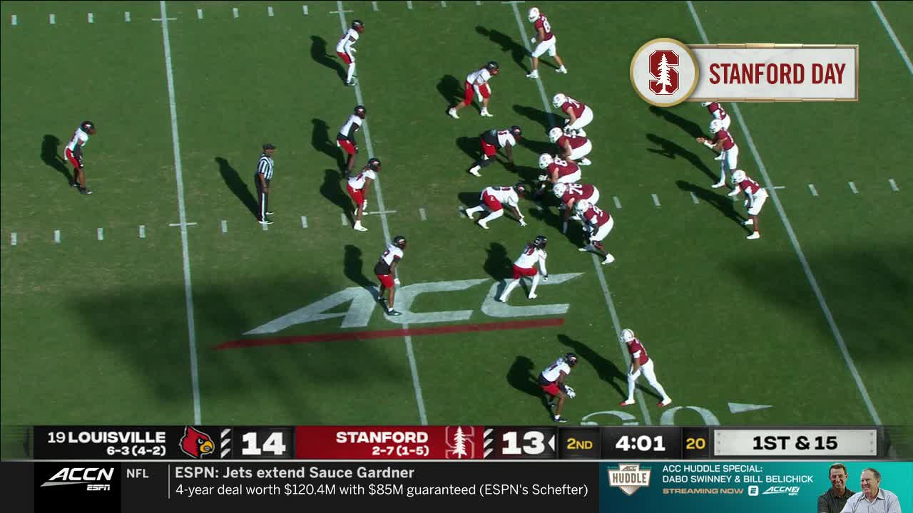 The Stanford offense is lined up at the line of scrimmage, ready for the snap. Louisville's defense is spread out, anticipating the play on this ACC Network broadcast.
