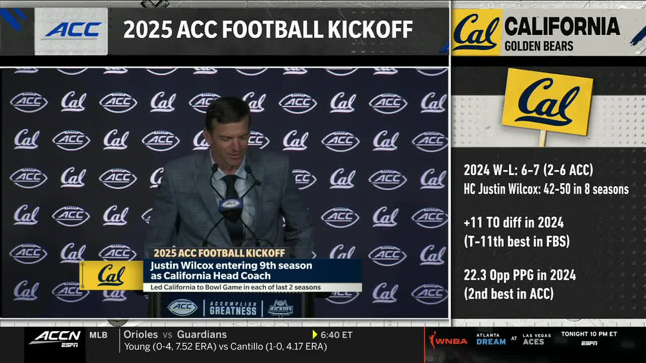 Justin Wilcox, the California Golden Bears head coach, is at the podium, speaking into a microphone. The ACC Network graphic on the screen highlights his upcoming ninth season.
