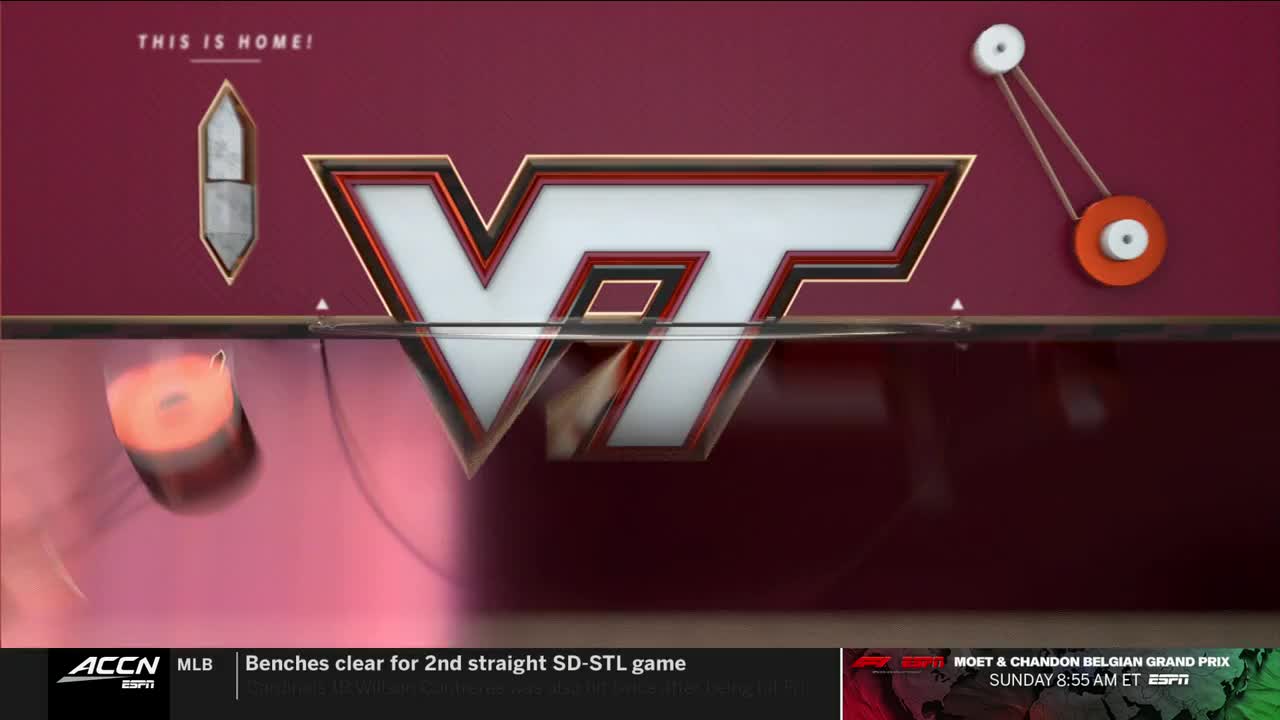 The Virginia Tech logo, outlined in gold, dominates the screen. A spinning, orange wheel-like object is partially visible, and the ACC Network logo is in the lower left corner.
