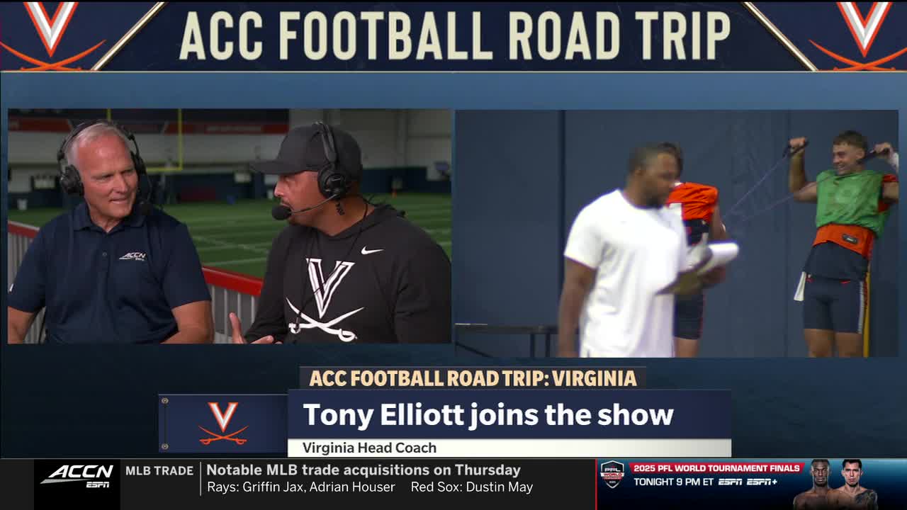Two men in headsets are seated at a table, talking on the ACC Network. Behind them, a coach in a white shirt holds a clipboard while a player stretches with resistance bands.

