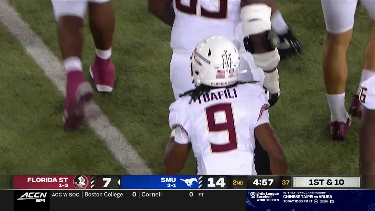 A player in a white jersey with the number nine is turned away from the camera, his helmet displaying a small American flag. The Florida State Seminoles are playing on the ACC Network, and the score is 7-14 in the second quarter.
