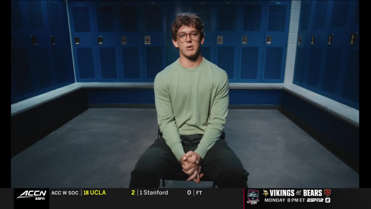 A young man in a green shirt sits in a locker room, speaking directly to the camera. The ACC Network logo and scores are visible at the bottom of the screen.
