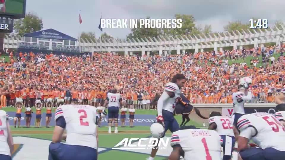 The players in white jerseys are on the field as the crowd roars in the background. A break is underway, with the clock showing 1:48.
