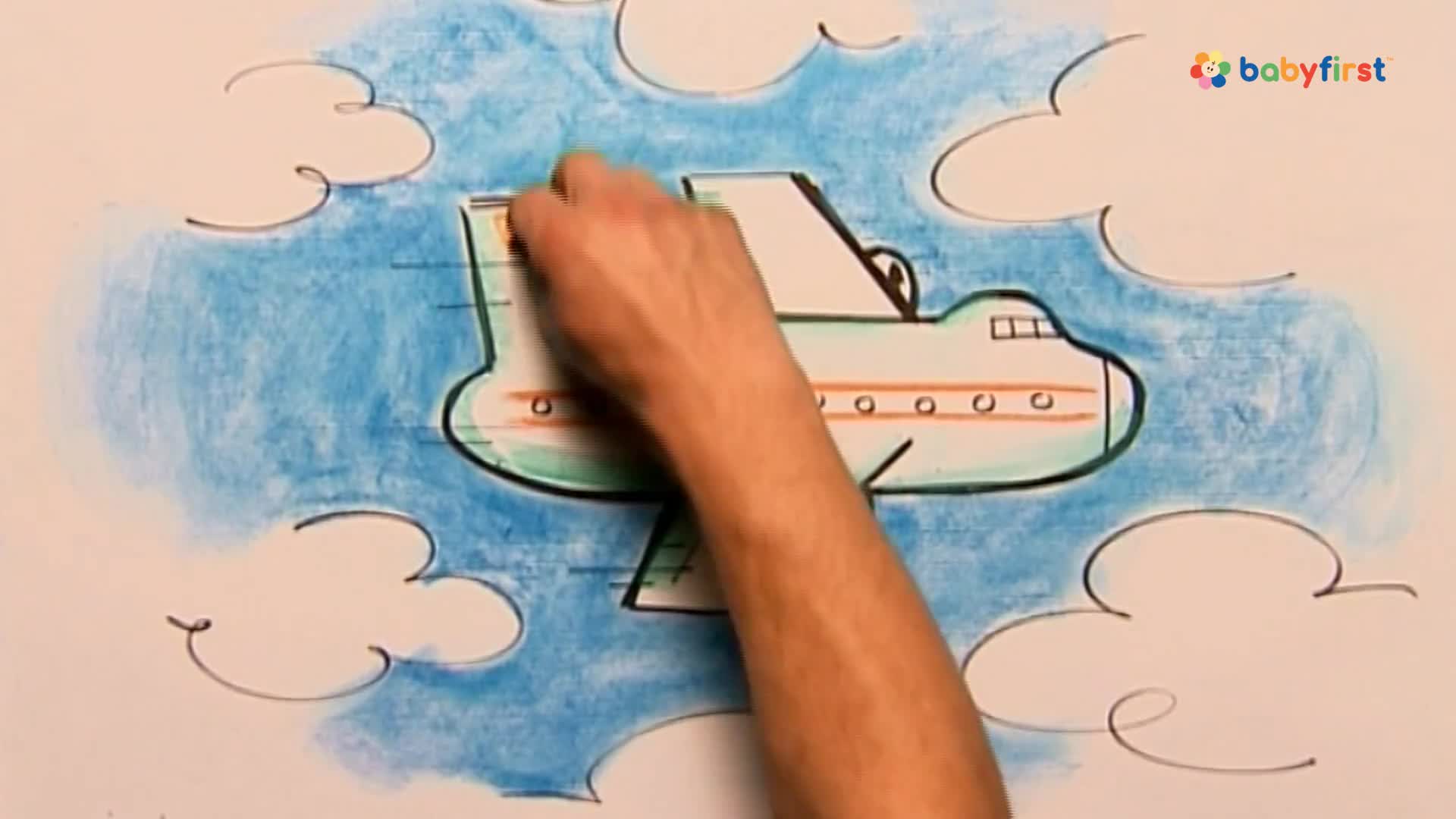 A hand is coloring the tail of a drawn airplane, which is set against a backdrop of blue crayon and simple white clouds. The plane has a green outline with orange details, and it's flying through the sky.
