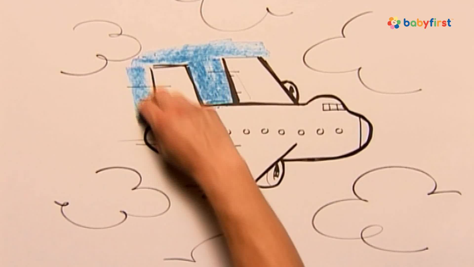 A hand is coloring the top of a drawn airplane blue with a crayon. The plane, outlined in black, is in the sky among simple cloud drawings.
