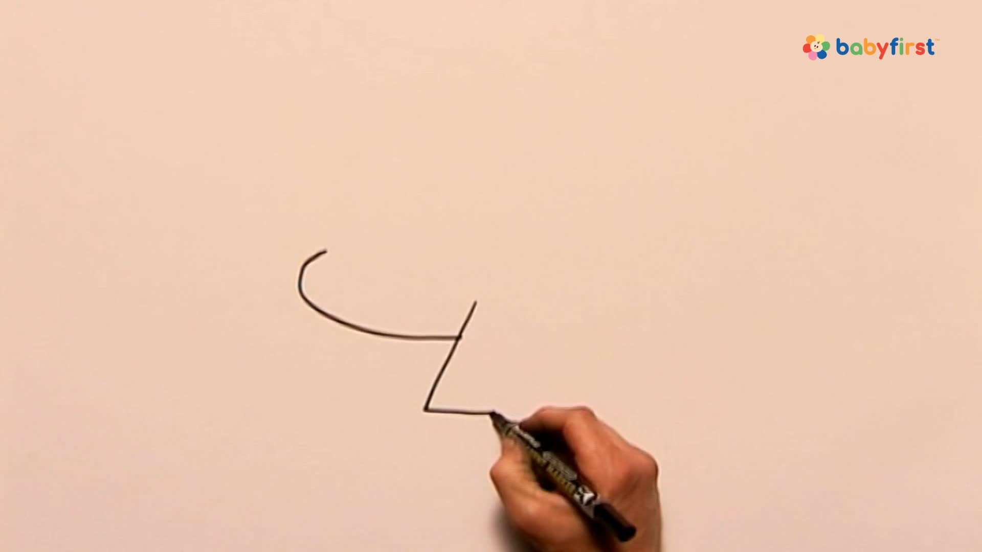 A hand holds a black marker, drawing a curved line and a few straight ones on a white surface. The lines are forming a simple shape, perhaps part of a larger drawing.
