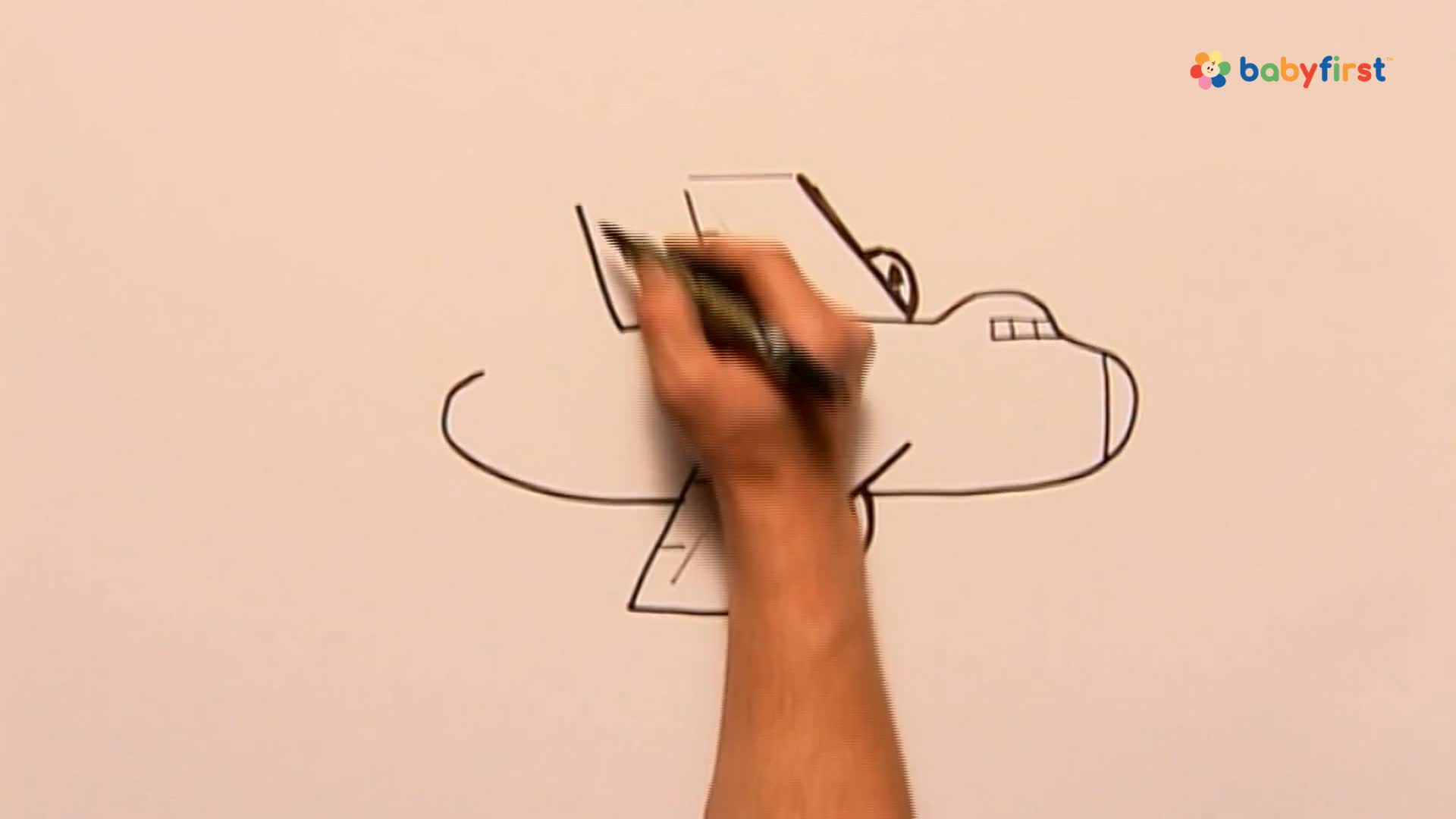 A hand is drawing an airplane with a black marker on a white surface. The plane's outline is taking shape, wing by wing, in a simple cartoon style.

