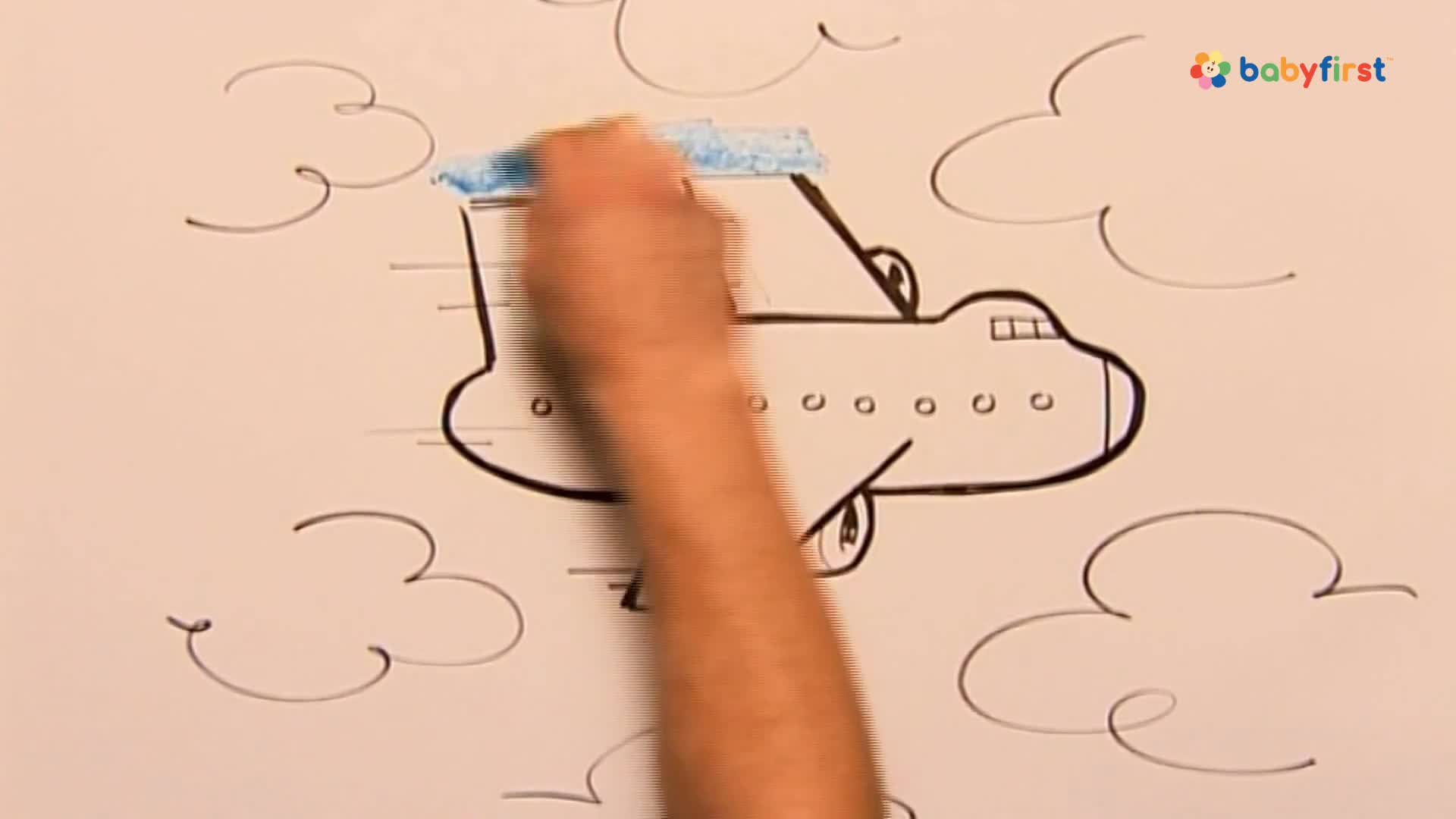 A hand uses a blue marker to color the top of a drawn airplane. The plane sits against a white background with sketched clouds, as a BabyFirst logo sits in the corner.
