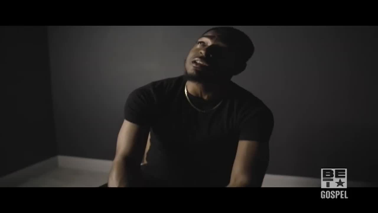 A man in a black t-shirt sits, looking upwards with his mouth open. The BET Gospel logo is visible in the corner.
