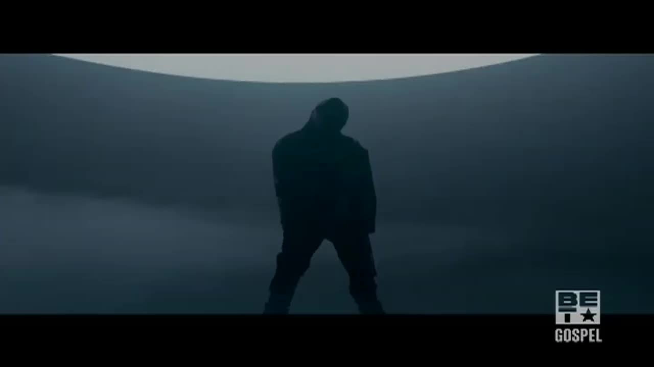 A lone figure stands silhouetted against a vast, curved backdrop. The BET Gospel logo sits in the corner, suggesting a performance is underway.
